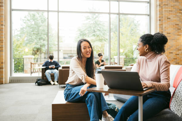 Two University students working together Two University students working together in modern student center post secondary education stock pictures, royalty-free photos & images