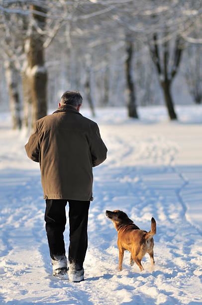 istock Man and dog in winter park 174660883