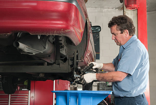 istock Auto Mechanic Degreasing Brakes on Raised Car 174661408