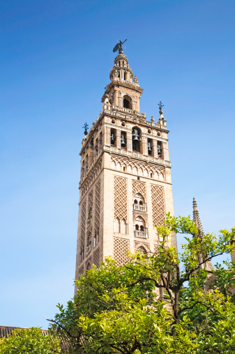 The Giralda is the bell tower of the Cathedral of Seville in Seville, Spain, one of the largest churches in the world and an outstanding example of the Gothic and Baroque architectural styles.