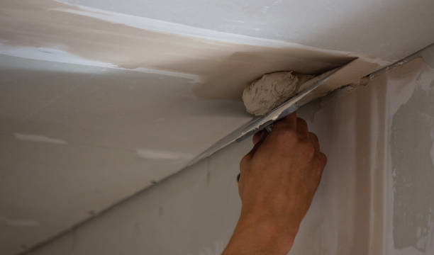 istock A man puts putty on a plasterboard ceiling. Putty for the joints of plasterboard sheets 1746617761