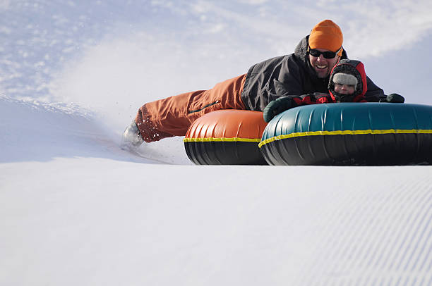 istock Father and Son Tubing 174662185