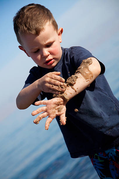 istock Child Playing in the Sand 174662536