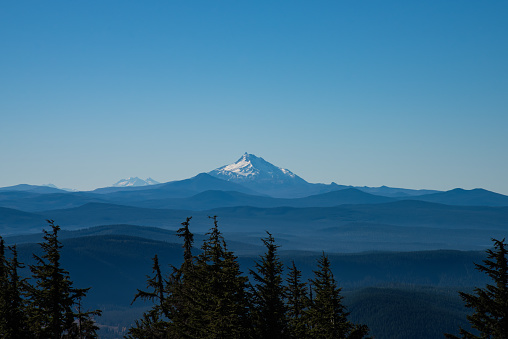 Mt Jefferson over layers of forested earth in the Pacific Northwest, Oregon