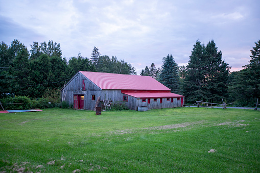 Rural landscape at dusk with old red barn.  Ottawa, Canada.