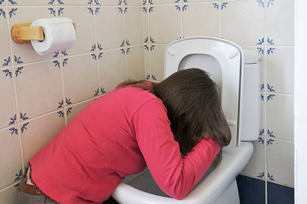 istock woman vomiting in toilet 174663555