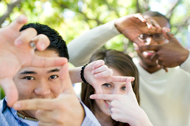 Diverse Group of Friends Friends making frames around their eyesALSO SEE... hand cropping photos stock pictures, royalty-free photos & images