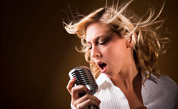 istock Female Vocalist With Microphone 174664399