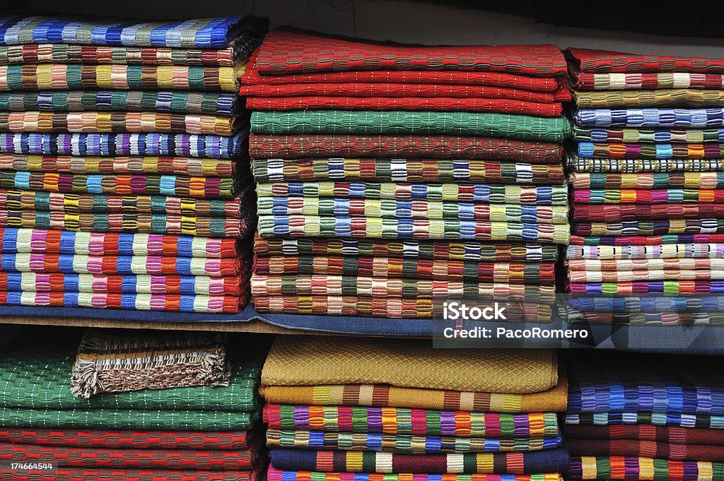 Guatemalan blankets "Folded, multicolor Guatemalan blankets at a market." Ancient Stock Photo