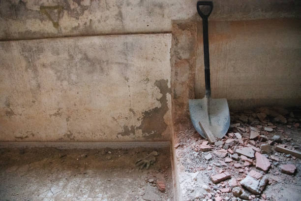 istock Shovel leaning against a wall under construction. Conceptual image, demolition vs construction, works, renovation. Copy space 1746645630
