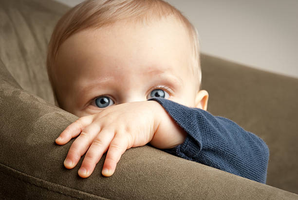 Peek-A-Boo Boy Peeking at Camera stock photo