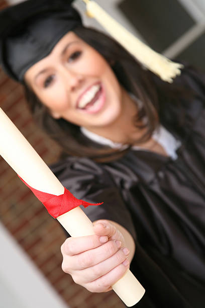 istock Smiling Female Graduate Holding Diploma 174664880