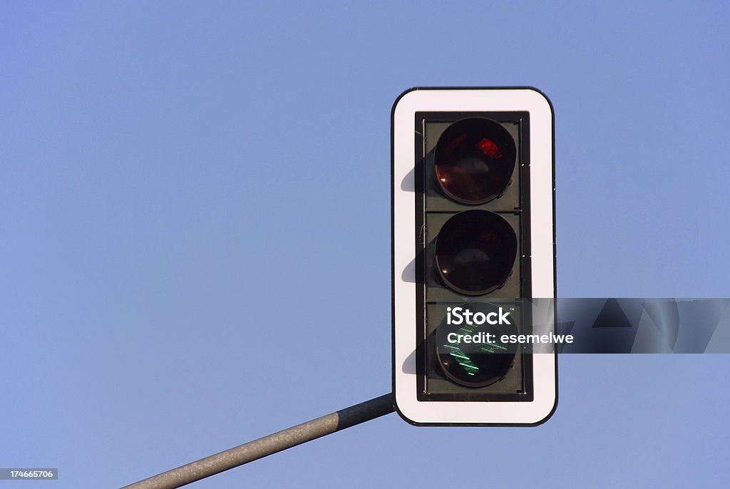 Traffic light - green arrow Traffic light - green arrow to the left against blue sky Left Turn Stock Photo