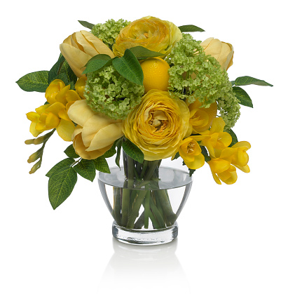 A yellow tulip and ranunculus bouquet in a footed rose bowl. The arrangement has an embedded clipping path to delete the reflection if desired. This arrangement was shot against a bright white background. Extremely high quality faux flowers.