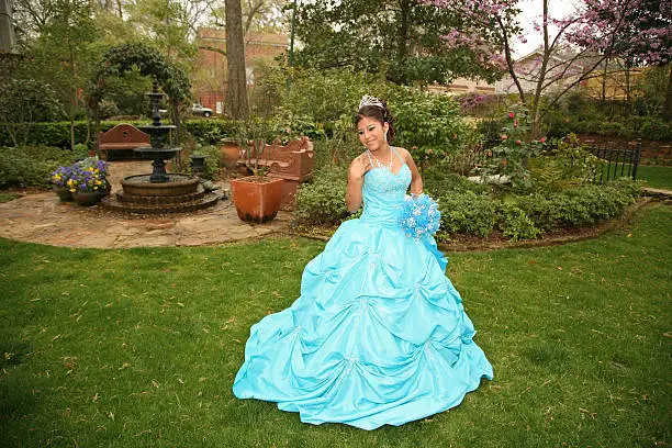 Young teen wearing a quinceanera dress on her 15th birthday.