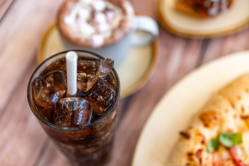 Paper straw in a cola drink with ice