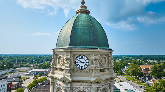 Image of Aerial close up of Columbia City courthouse clock tower with dome and blue sky