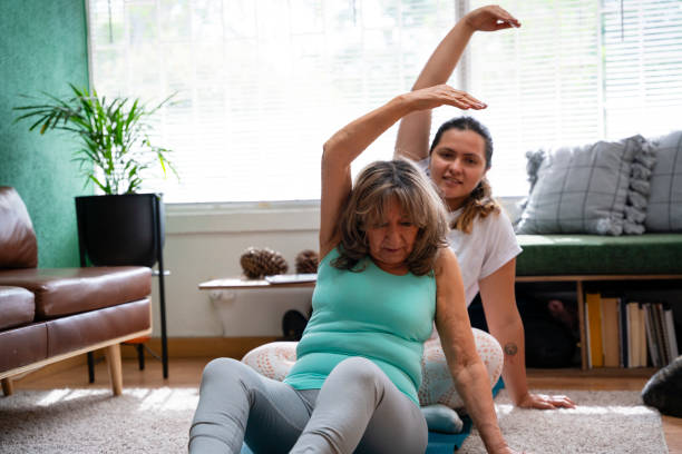 istock Generational Wellness: Granddaughter Teaching Grandma Home Stretching Exercises 1746665178