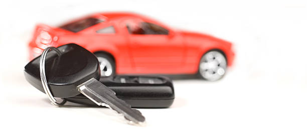 New car "Car keys and red car in the very strong depth of field, white background, studio isolated.Selective focus, 60 mm Nikkor.New car, car rental, car loan concept." car finance stock pictures, royalty-free photos & images