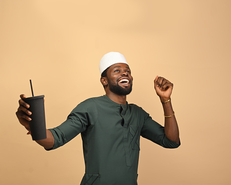 Portrait of happy smiling young African male employee showing thumb up gesture looking at camera expressing loyalty trust to her company, satisfied male client customer recommending goods or service