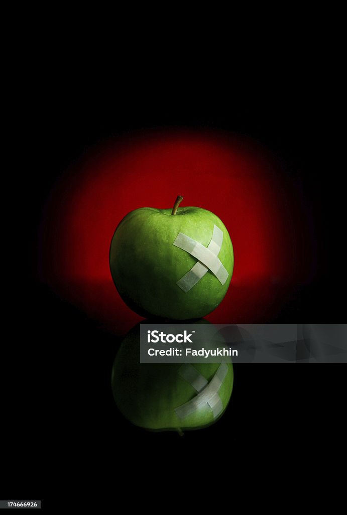 Red Light Picture of an apple with red light behind it. Adhesive Bandage Stock Photo