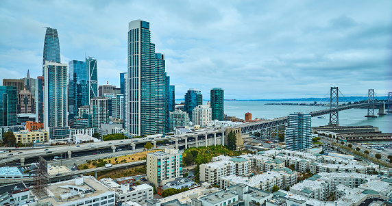 Image of Aerial over Bayside Village with San Francisco skyscrapers and Oakland Bay Bridge