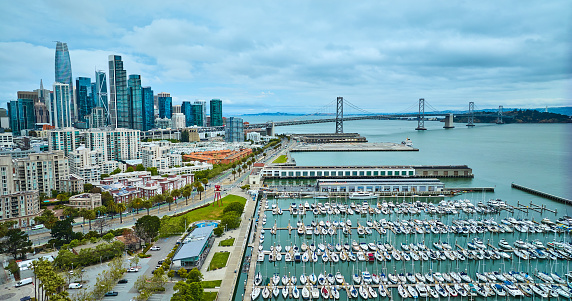 Image of Aerial South Beach Harbor with Oakland Bay Bridge leading to downtown skyscrapers
