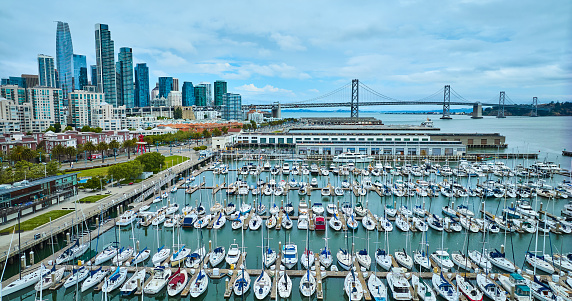 Image of Aerial South Beach Harbor yachts and boats with Pier 40 and Oakland Bay Bridge with city