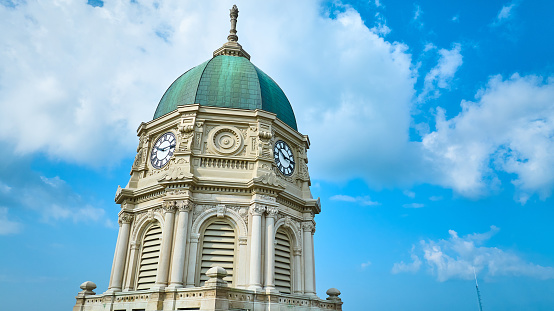 Image of Aerial upward view of Columbia City courthouse clock tower with dome and blue sky with clouds
