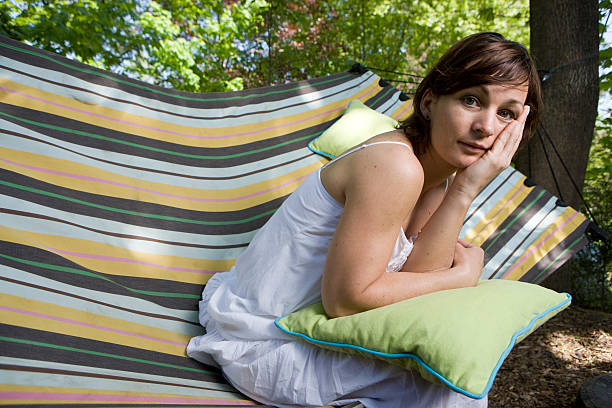 istock Woman in a hammock looking at camera 174667506