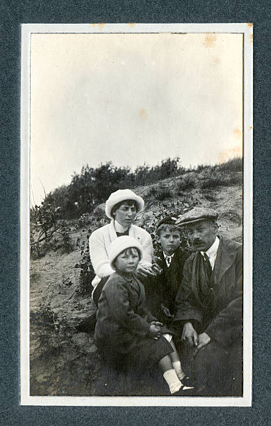 Edwardian Family at in the Sand Dunes - Vintage Photograph Vintage photograph of an Edwardian family on a day out at the seaside sitting in the sand dunes. Knokke, Belgium. edwardian style photos stock pictures, royalty-free photos & images