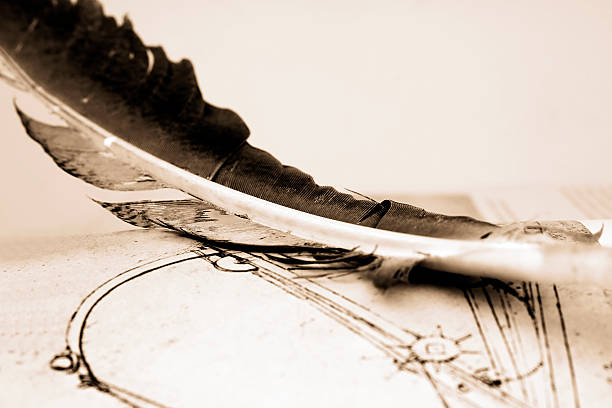 a quill and a sheet of paper