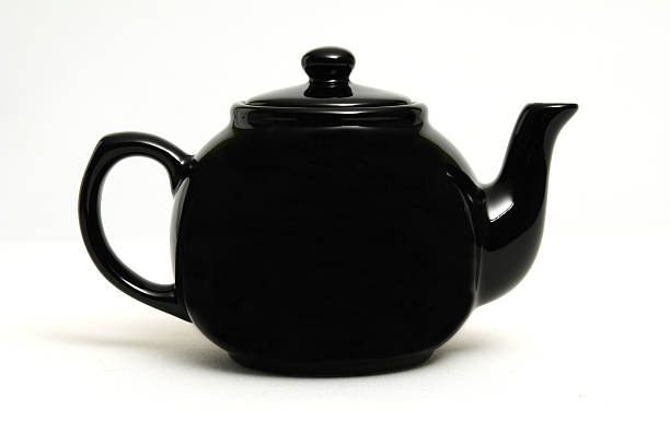 black tea pot stock photo