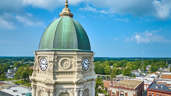 Image of Close up aerial of Columbia City courthouse clock tower with dome and blue sky