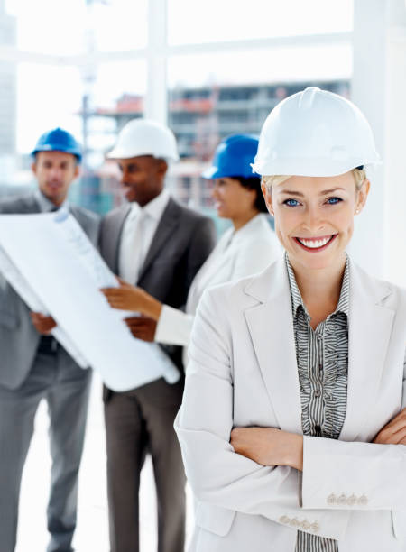 istock Female engineer smiling with colleagues in the background 174669192