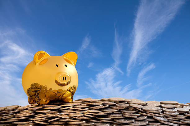 Happy Gold Piggy Bank on pile of Coins stock photo