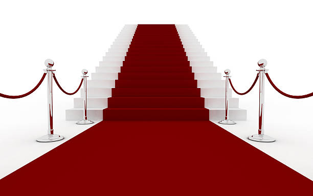 istock Red carpet leading to white stairs 174669561