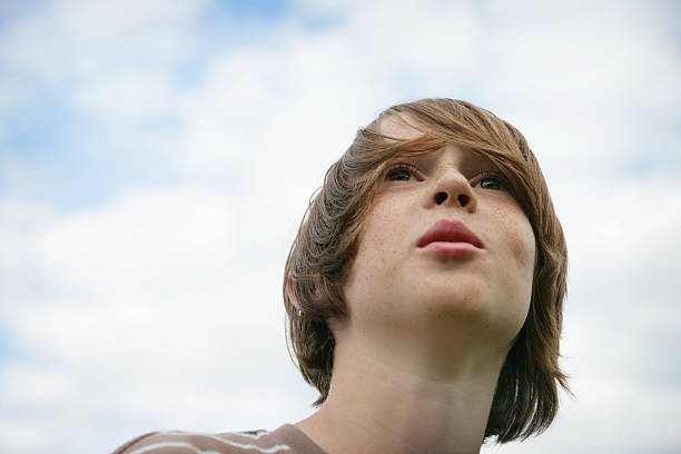istock Cute Young Boy with Head in the Clouds 174669799