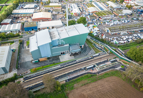 Exeter, UK. 20 October 2023. Aerial view over Marsh Barton Train Station and the exterior of the Exeter Energy Recovery Facility