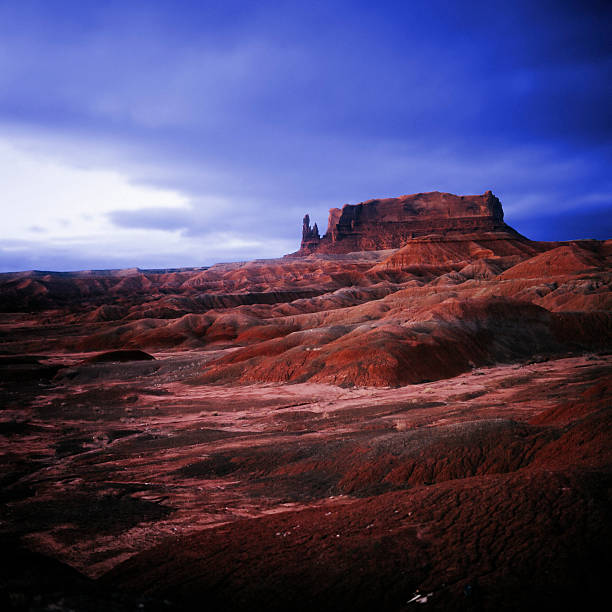 Dark red rocks in the dessert under fading light