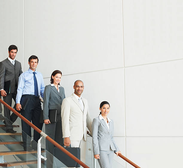 istock Group of business people moving downstairs 174670579