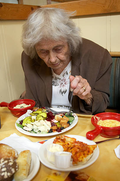 istock Ninety year old lady eating salad at restaurant 174671131