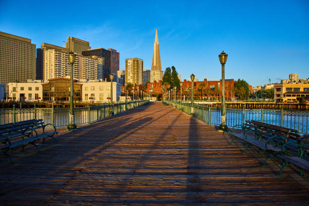 istock Golden light on Pier 7 path leading to shore lit by sunrise with Transamerica Pyramid 1746712949