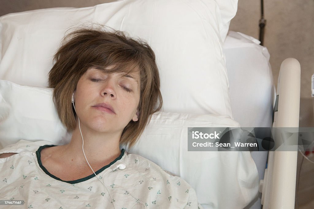 hospital Bed - Woman in Pain This young woman is in the middle of labor pains. You can see it on her face. Adult Stock Photo