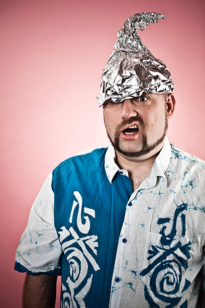 Tin foiled man A goofy guy wearing a tin foil hat. tin foil hat stock pictures, royalty-free photos & images