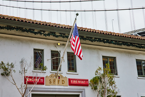 Image of Hanging American Flag outside San Francisco Fire Department upper window view