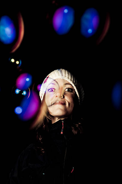 istock young woman smiling behind huge soap bubbles 174671742