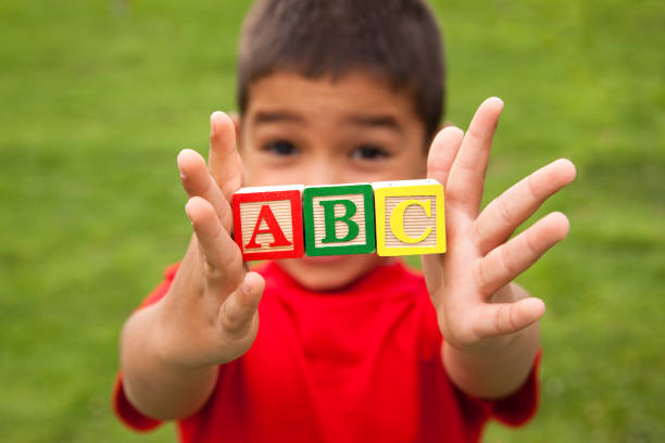 Boy with ABC blocks "Children education concept, a preschool boy holding ABC wooden toy blocks. You may also like:" a b c stock pictures, royalty-free photos & images