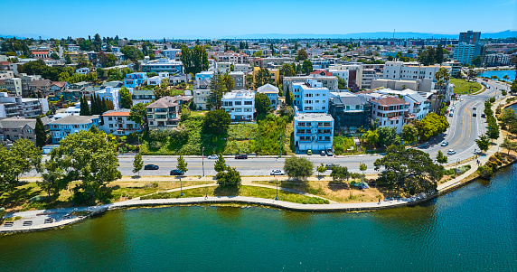 Image of Lake Merritt shoreline with residential apartments on other side of road and walking path aerial