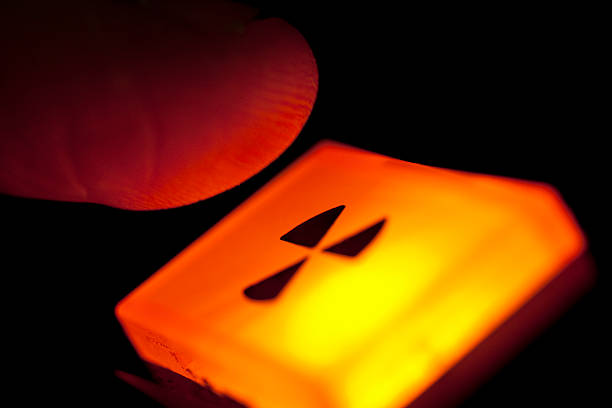 Push the button; radiation warning or nuclear war; last resort Finger hovering over an illuminated radiation warning sign - or the nuclear option (...or a piece of laboratory equipment actually). nuclear weapon stock pictures, royalty-free photos & images